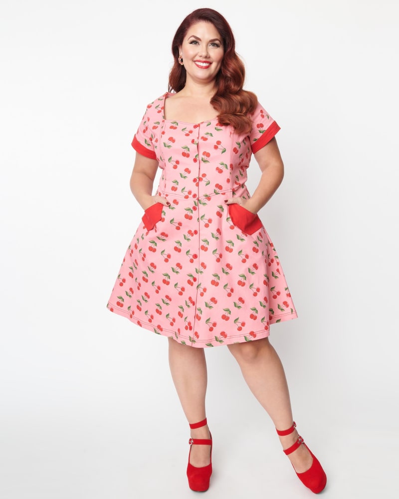 Front of a model wearing a size 5X Unique Vintage Pink Denim & Cherry Print Fit & Flare Dress in Pink by Unique Vintage. | dia_product_style_image_id:287434